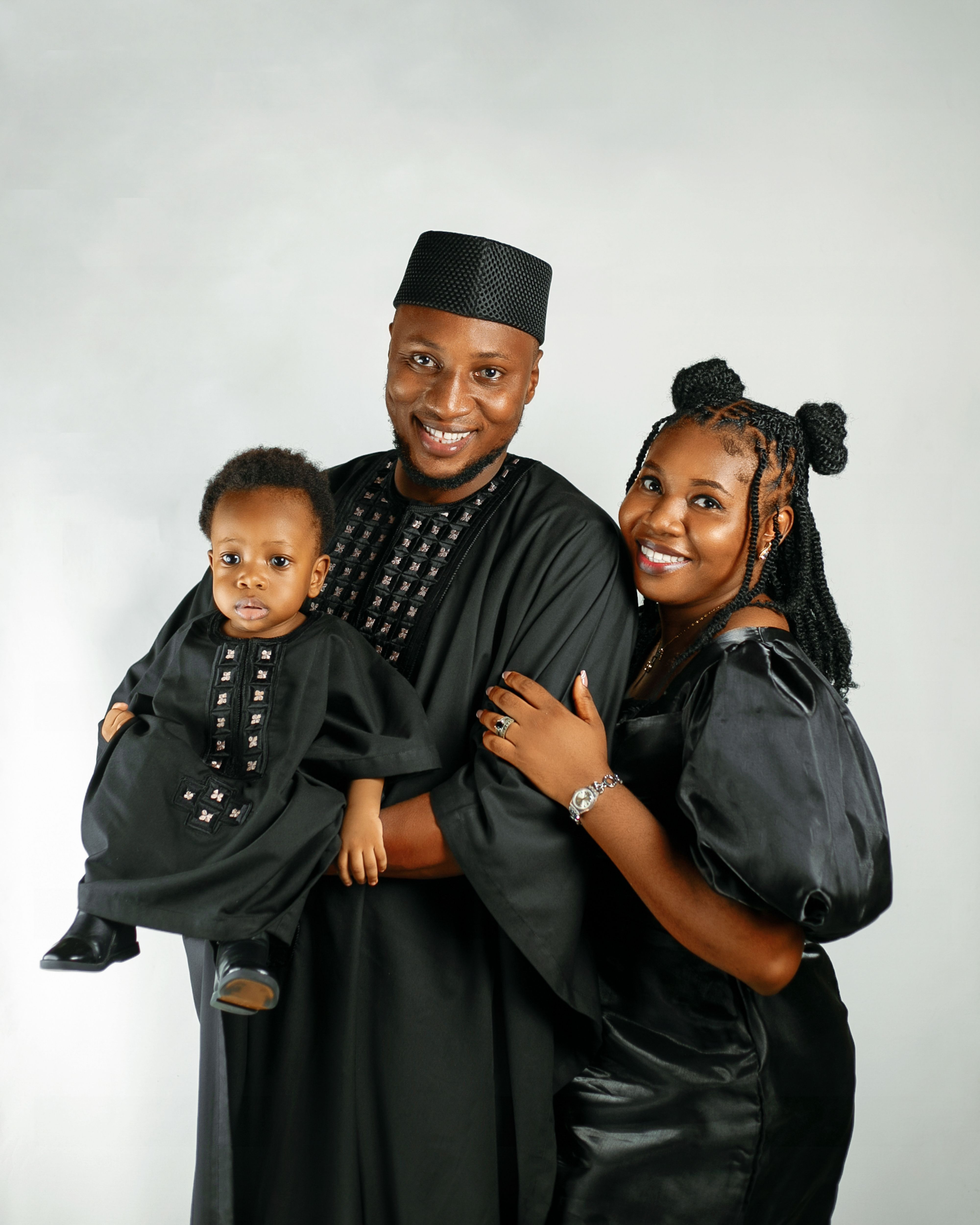 Parents and their child together in matching black outfits