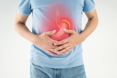 An image of a man holding his stomach with an illustration showing stomach ulcer pain inside the belly.