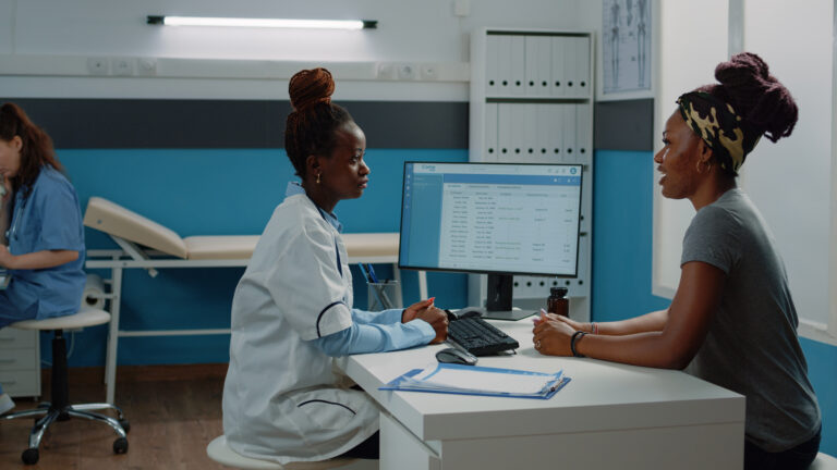 A photo of an ongoing medical consultation with a doctor and her patient
