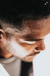 An image of a man with visible sweat on his face showing excessive sweating in hot weather
