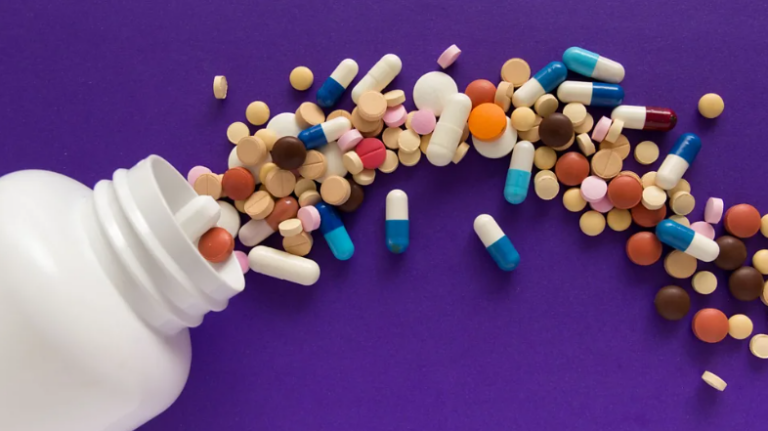 Small medicine container with supplement pills spilling out, representing daily supplement use